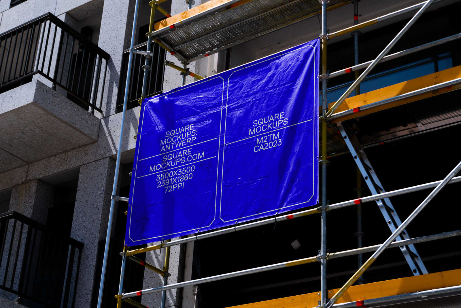 Blue square outdoor mockup banners hanging on a scaffold against a building exterior, designers' advertising space, high resolution.